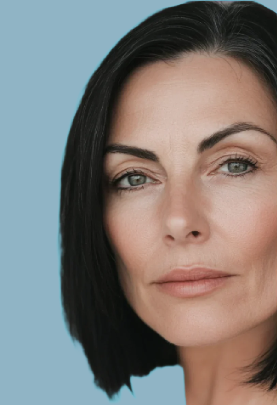 Woman with short dark hair against a light blue background